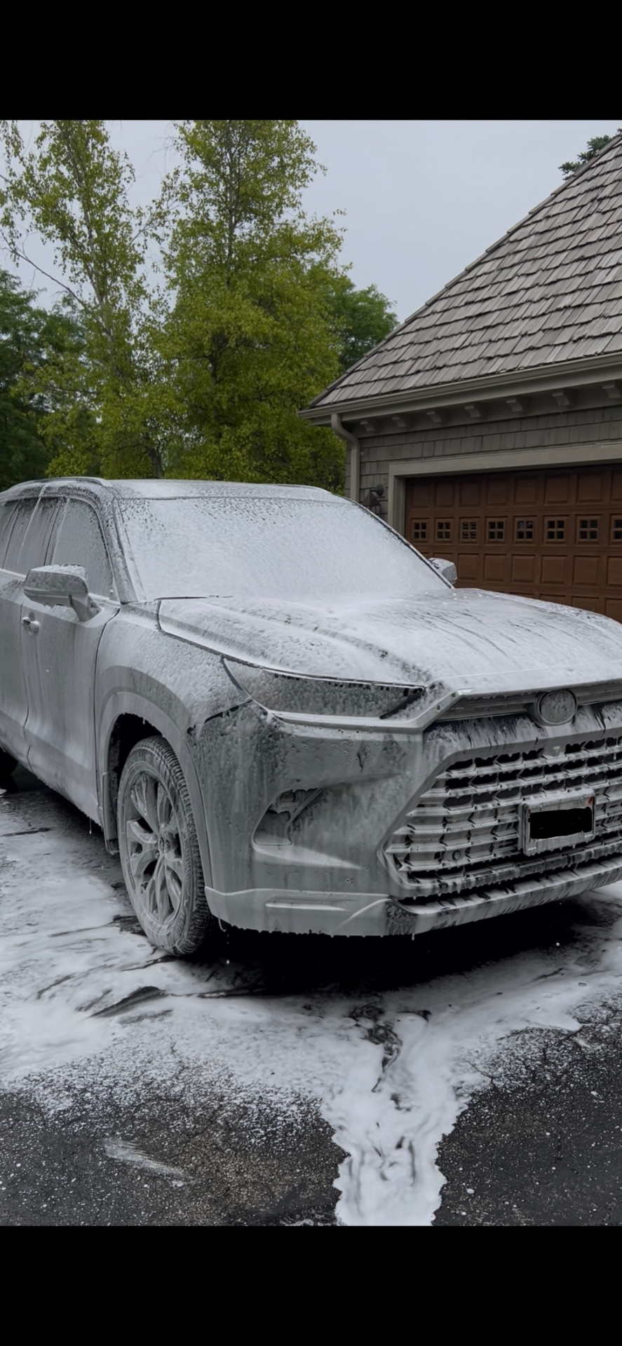 Toyota SUV covered in thick snow foam pre-wash during exterior detail